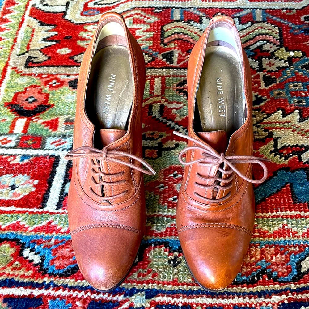 Brown leather wingtip saddle style heels.